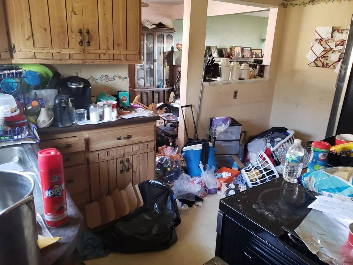 Cluttered kitchen of a house sold as-is to a cash buyer - no cleanout needed